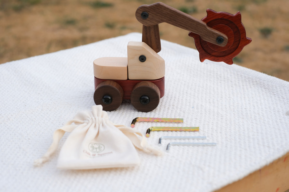 Padauk & Maple Trench Digger with an Oak & Sprout cotton drawstring pouch and four child-size Allen keys on a white textured throw