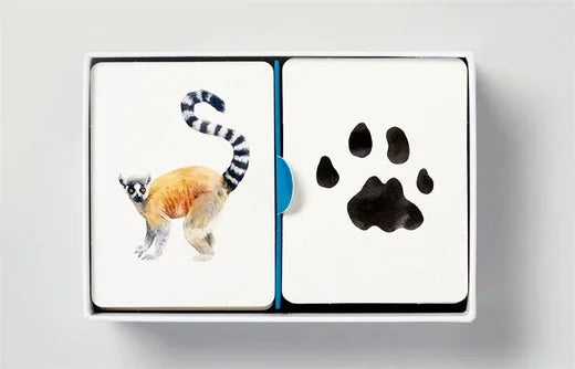 Match a Track Game card decks showing ring-tailed lemur illustration paired with matching black paw print track card