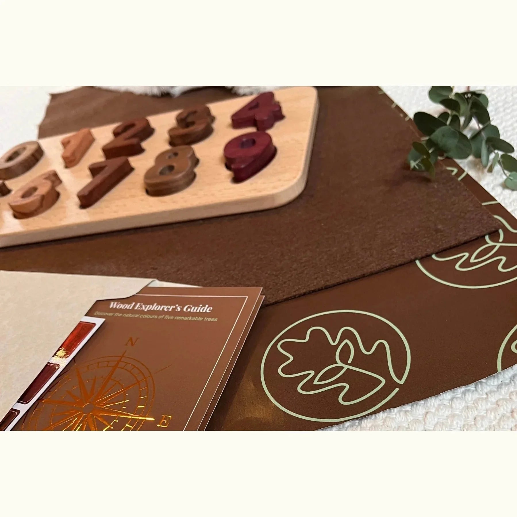 Early Literacy & Numeracy Bundle number puzzle partially assembled, Tigerwood, Walnut and Purpleheart pieces scattered on map