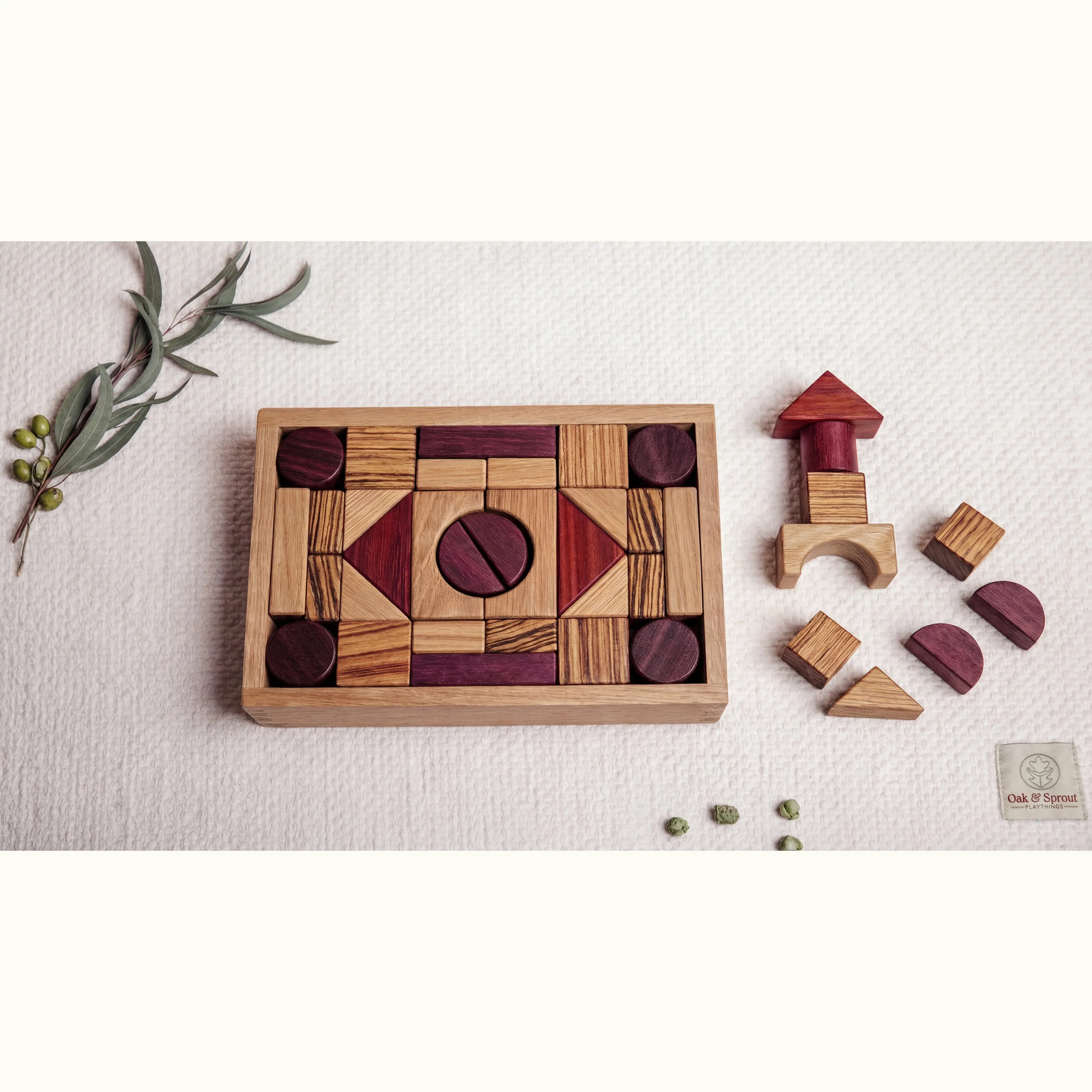 60pc exotic hardwood building blocks arranged in geometric mosaic in oak tray, with arches, cylinders and triangles in Purple