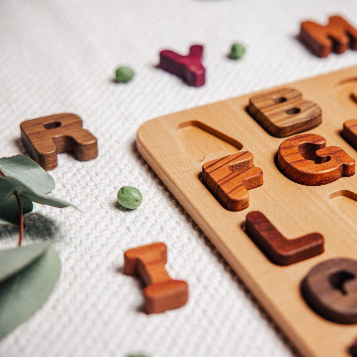 Wooden alphabet puzzle with letters on a light background