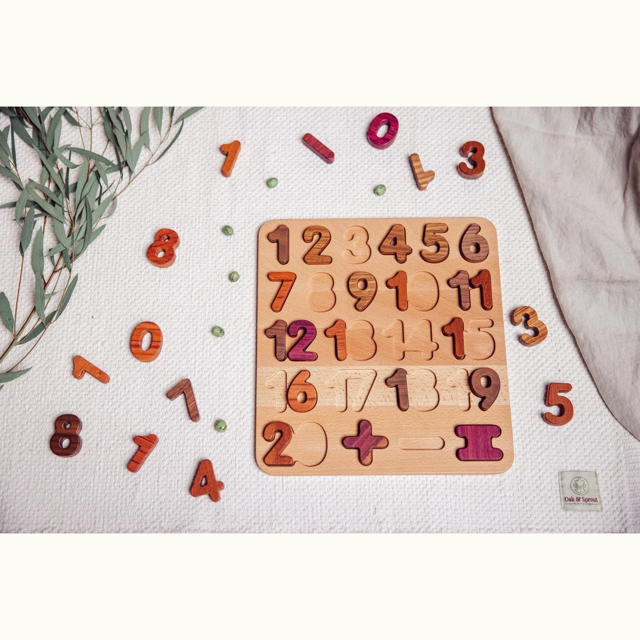 Extended Wooden Number Puzzle partially assembled, Tigerwood, Mahogany, Walnut and Purpleheart pieces scattered on white play