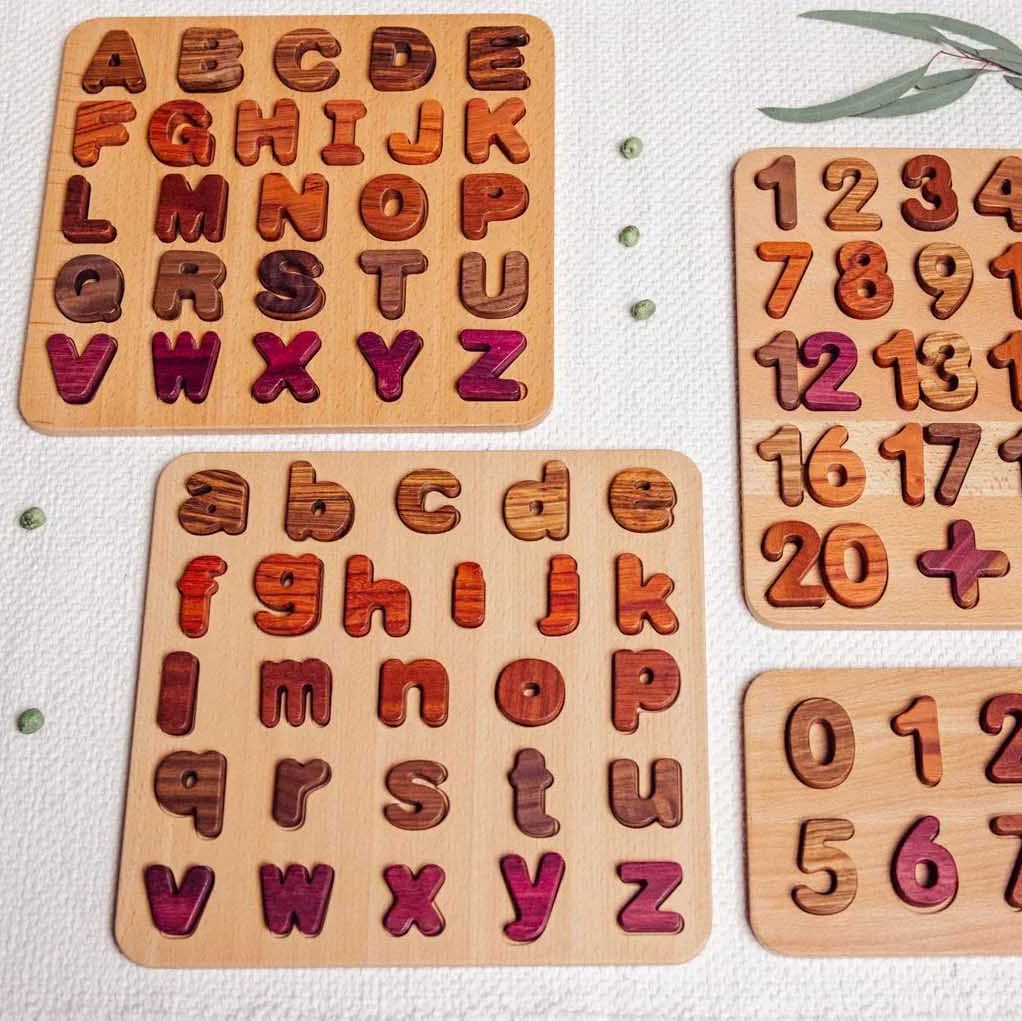 Set of wooden letter and number puzzles on a light background