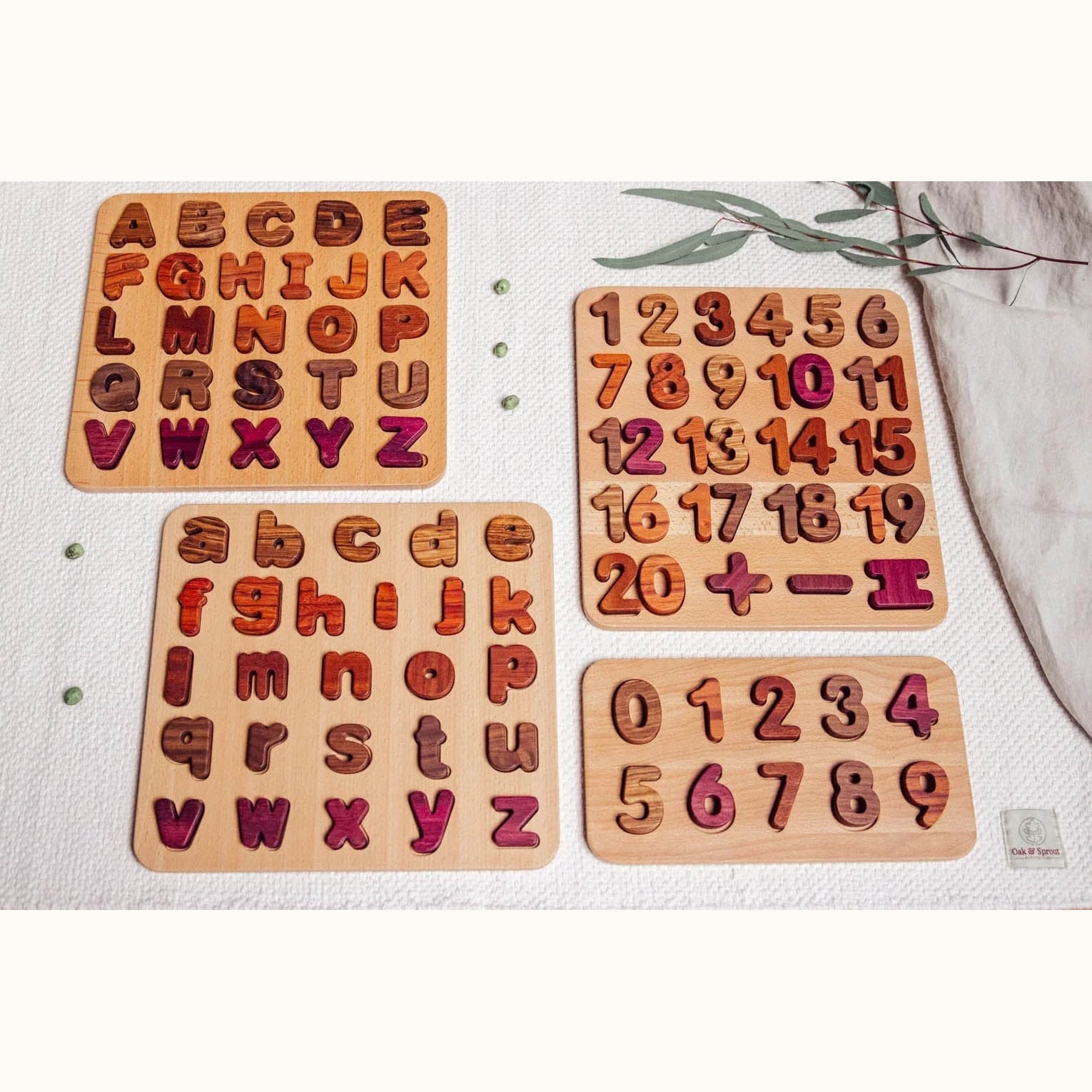 Oak & Sprout 0–9 Numbers Puzzle assembled in flat-lay with Purpleheart, Tigerwood and Walnut pieces on white linen