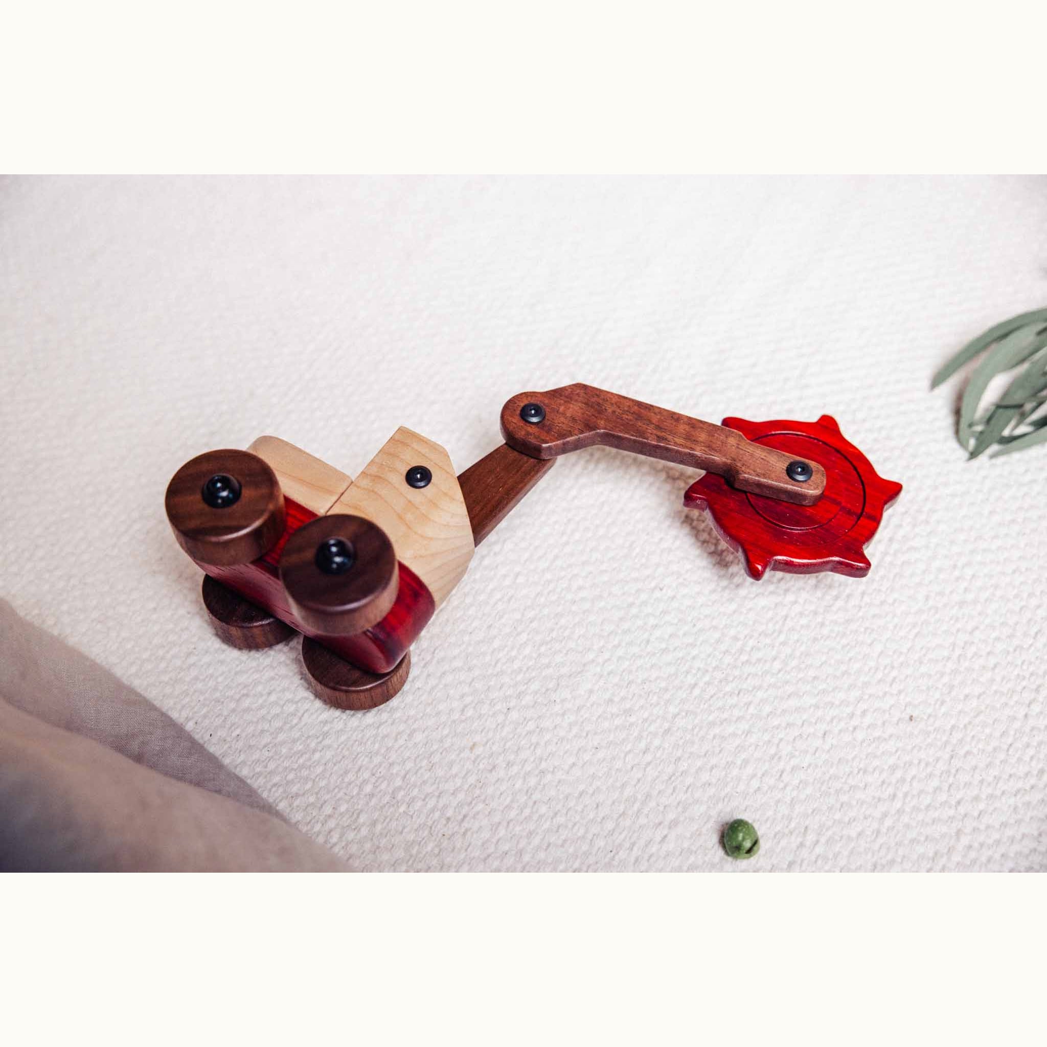Padauk & Maple Trench Digger overhead view on cream playmat, showing maple body, walnut chassis and padauk tracked base