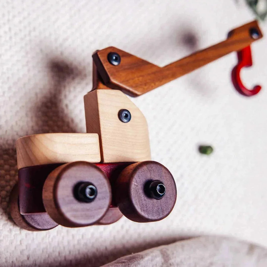 Complete Wooden Vehicles Set crane truck detail: maple cab, walnut crane arm, padauk hook, on white playmat