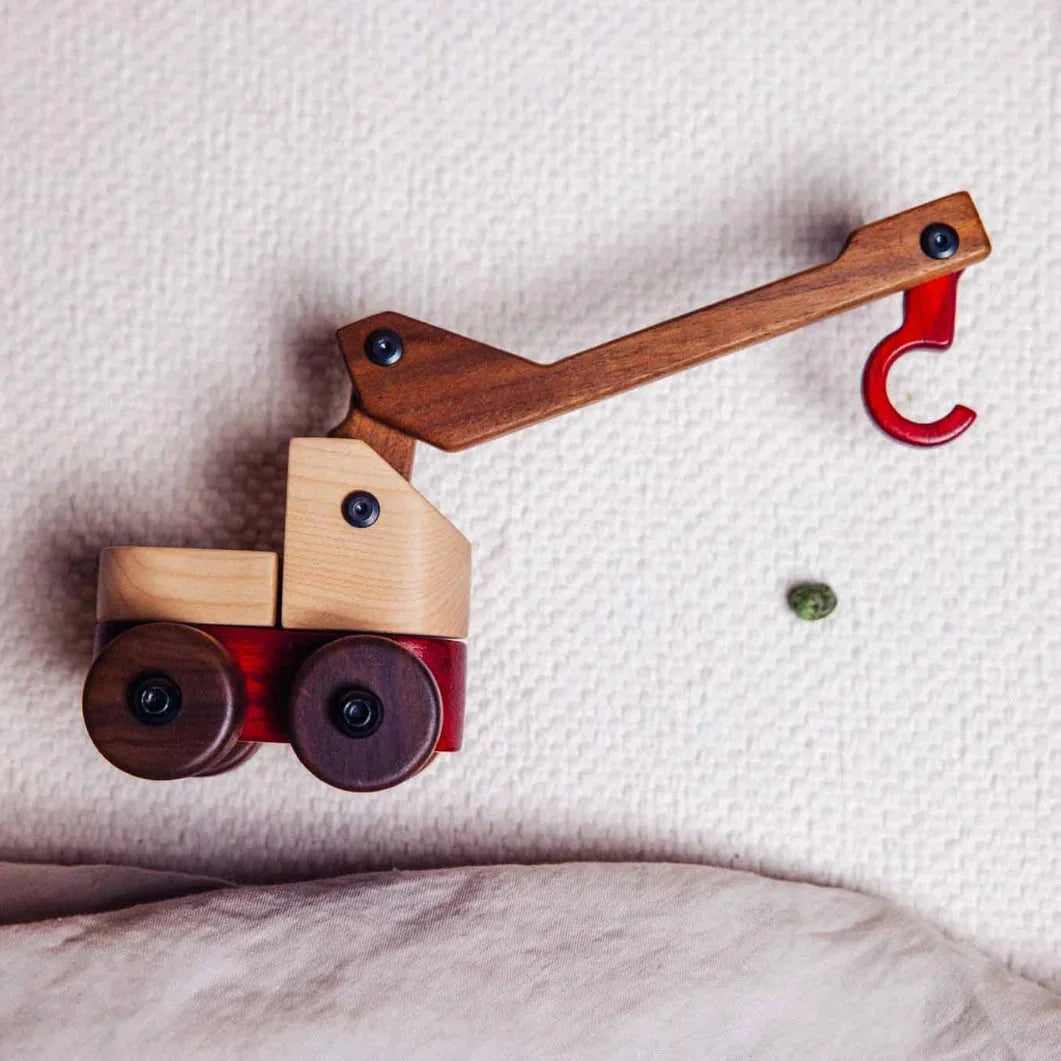Complete Wooden Vehicles Set crane truck close-up, maple cab, walnut arm, padauk hook, on white knit surface