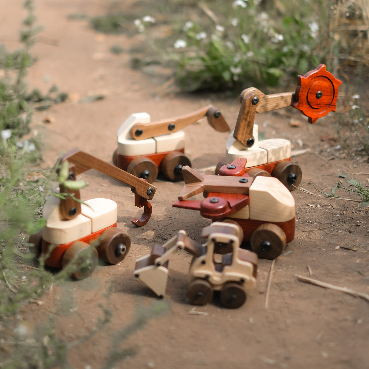 The Complete Wooden Vehicles Set on a dirt path: crane, excavator, trench digger, aeroplane and Maple Digger together