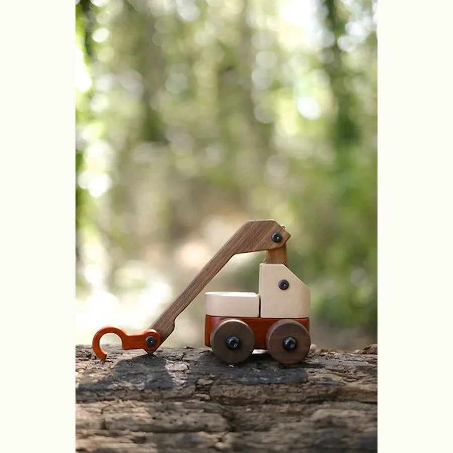 Walnut & Maple Crane lifestyle shot on tree bark outdoors, showing maple cab, walnut boom arm and padauk hook in natural