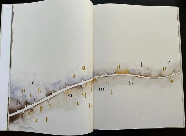 Open copy of The Lost Words book showing watercolour illustration with gold gilt lettering, inspiring the Oak & Sprout