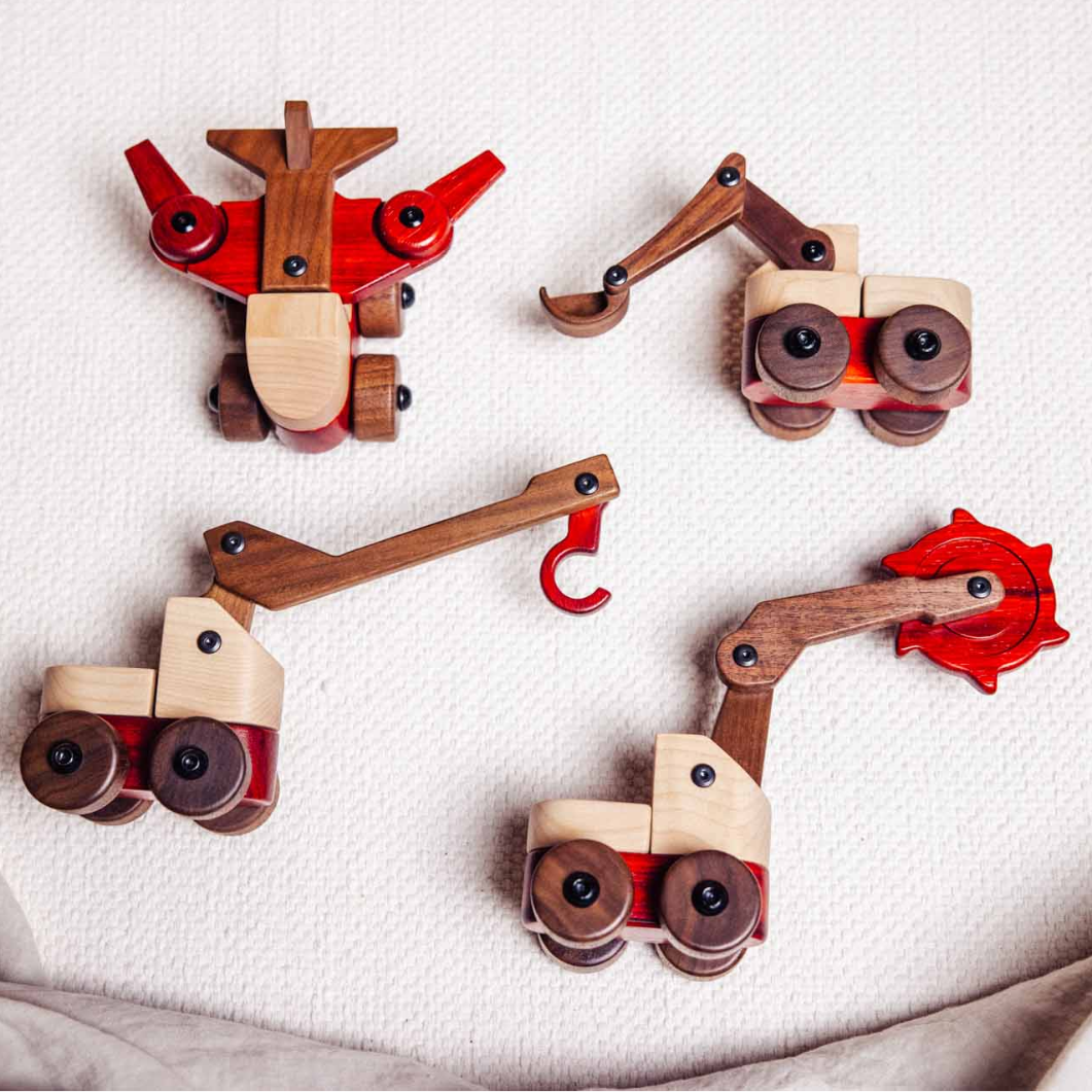 Wooden toy vehicles arranged in a circular pattern on a textured surface