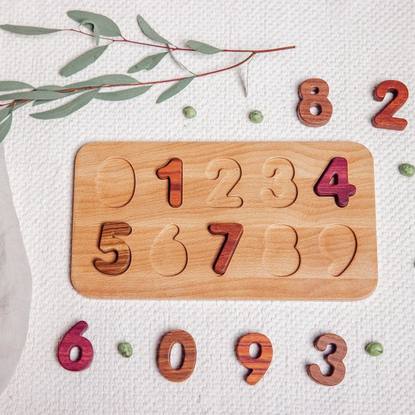 Wooden number puzzle with scattered numbers on a light background