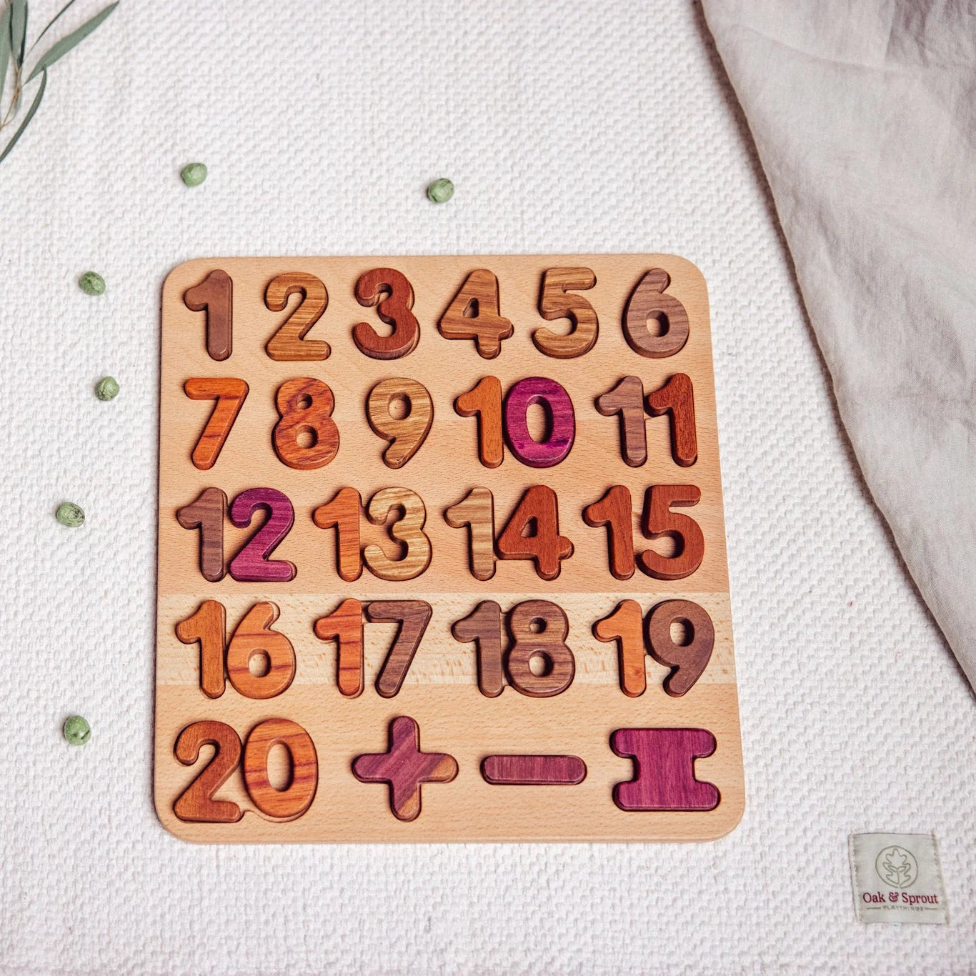 Extended Wooden Number Puzzle 1–20 fully assembled, showing Tigerwood, Mahogany, Walnut and Purpleheart pieces on linen playm