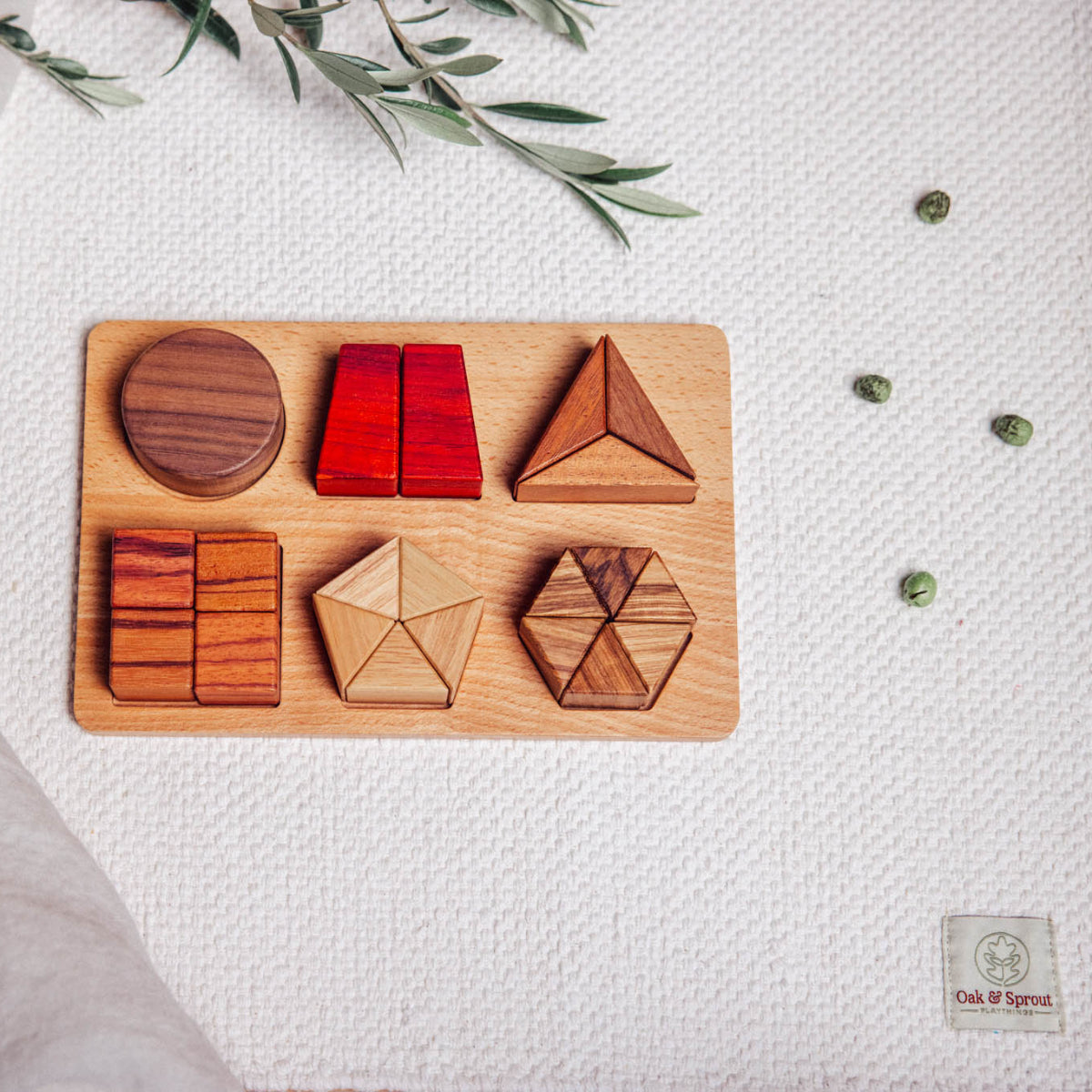 Wooden geometric shapes on a wooden board with a white textured background