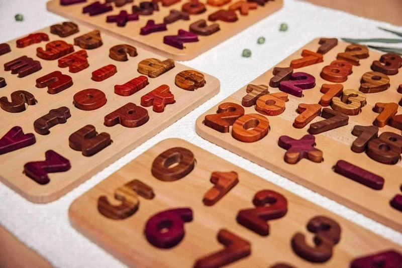 Wooden Number Puzzle 0–9 assembled on linen mat, digits in purpleheart, walnut, tigerwood, mahogany and zebrano inset pockets